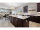 Well-lit kitchen with an island, granite countertops, and stainless steel appliances at 20040 E Kestrel St, Queen Creek, AZ 85142