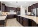 Spacious kitchen featuring dark cabinetry, granite counters, stainless steel appliances and large center island at 20040 E Kestrel St, Queen Creek, AZ 85142