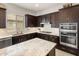 Elegant kitchen featuring granite countertops, stainless steel appliances, and custom cabinetry at 20040 E Kestrel St, Queen Creek, AZ 85142