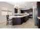 Modern kitchen with dark wood cabinetry, granite countertops, and stainless steel appliances at 20040 E Kestrel St, Queen Creek, AZ 85142