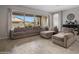 Bright living room with tile flooring and large windows overlooking the pool area at 20040 E Kestrel St, Queen Creek, AZ 85142