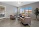Bright living room with neutral walls, tiled floors, large windows, and comfortable seating area at 20040 E Kestrel St, Queen Creek, AZ 85142