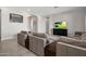 Open concept living room with a large sectional sofa and neutral color palette at 20040 E Kestrel St, Queen Creek, AZ 85142