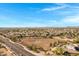 Expansive aerial view of the community, showcasing its layout, nearby road, and open spaces at 20331 N Fletcher Way, Peoria, AZ 85382