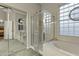 Bathroom boasts a glass shower, soaking tub, and glass block window at 20331 N Fletcher Way, Peoria, AZ 85382