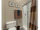 Bathroom with a toilet, a shower with glass doors and neutral-colored walls at 20331 N Fletcher Way, Peoria, AZ 85382