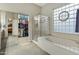 Bathroom boasts a glass block window, soaking tub, and glass enclosed shower at 20331 N Fletcher Way, Peoria, AZ 85382