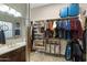 Walk-in closet connects to bathroom with built-in shelving, ample storage and natural light at 20331 N Fletcher Way, Peoria, AZ 85382