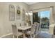 Dining room with a table set for eight, modern chandelier, and sliding glass doors to the patio at 20331 N Fletcher Way, Peoria, AZ 85382