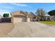 Spacious driveway leads to a well-maintained home with a three-car garage and desert landscaping at 20331 N Fletcher Way, Peoria, AZ 85382