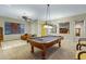 Bright and spacious game room with a pool table, cozy seating area, and elegant light fixtures at 20331 N Fletcher Way, Peoria, AZ 85382