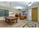 Game room featuring a classic pool table, fireplace, comfortable seating, and ample natural light at 20331 N Fletcher Way, Peoria, AZ 85382