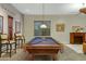 Well-appointed game room with a pool table, cue rack, fireplace, and comfortable seating area at 20331 N Fletcher Way, Peoria, AZ 85382