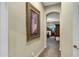 Hallway view towards bedroom, showcasing a stylish painting and architectural details at 20331 N Fletcher Way, Peoria, AZ 85382