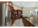 Kitchen with dark wood cabinetry, granite countertops, stainless steel appliances, and an island with bar seating at 20331 N Fletcher Way, Peoria, AZ 85382