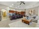 An open concept living room featuring a large kitchen island and comfortable seating area at 20331 N Fletcher Way, Peoria, AZ 85382