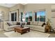 Bright living room featuring multiple large windows, comfortable seating, and a neutral color palette at 20331 N Fletcher Way, Peoria, AZ 85382