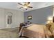 Bright main bedroom with stylish decor, ceiling fan, and doorway to closet at 20331 N Fletcher Way, Peoria, AZ 85382