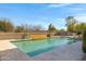 Backyard pool featuring a tranquil waterfall feature and a tile surround, ideal for outdoor enjoyment at 20331 N Fletcher Way, Peoria, AZ 85382