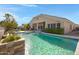 Sparkling pool with a beautiful waterfall feature and lush landscaping, perfect for relaxing at 20331 N Fletcher Way, Peoria, AZ 85382