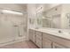 Bright bathroom featuring double sinks and a shower with glass door at 20408 N Tanglewood Dr, Sun City West, AZ 85375