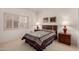 Bright bedroom with a large window, neutral walls, carpet, and a comfortable bed with colorful bedding at 20408 N Tanglewood Dr, Sun City West, AZ 85375