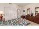 Bright bedroom with a closet and dresser with mirror at 20408 N Tanglewood Dr, Sun City West, AZ 85375