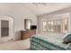 Bright bedroom featuring a bay window, walk-in closet, carpet and neutral walls at 20408 N Tanglewood Dr, Sun City West, AZ 85375