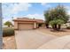 Inviting single-story home with a well-manicured desert landscape and attached garage at 20408 N Tanglewood Dr, Sun City West, AZ 85375