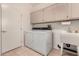 Functional laundry room equipped with washer, dryer, sink, and overhead cabinets for storage at 20408 N Tanglewood Dr, Sun City West, AZ 85375
