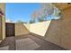Private patio with pavers and gravel offers a secluded outdoor space, enclosed by stucco walls for added privacy at 2102 W Marlette Ave, Phoenix, AZ 85015
