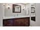 Bathroom featuring a wood vanity, white countertop, and modern lighting fixtures at 2102 W Marlette Ave, Phoenix, AZ 85015