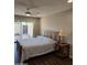 Bedroom with a wood-framed bed, ceiling fan, and sliding glass doors to the outdoor patio at 2102 W Marlette Ave, Phoenix, AZ 85015