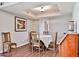 Inviting dining area with a round table, wood chairs, and a stylish light fixture at 2102 W Marlette Ave, Phoenix, AZ 85015