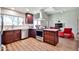 Modern kitchen featuring stainless appliances, wood cabinets, island and access to the living room at 2102 W Marlette Ave, Phoenix, AZ 85015