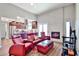 Open-concept living room with a fireplace, dark wood cabinets, and a view of the modern kitchen at 2102 W Marlette Ave, Phoenix, AZ 85015