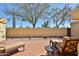 Outdoor patio with brick pavers, comfortable seating, and mature landscaping for relaxing and entertaining at 2102 W Marlette Ave, Phoenix, AZ 85015