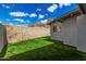 Serene backyard with lush green lawn and brick perimeter wall, perfect for relaxation at 2202 E Lincoln Dr, Phoenix, AZ 85016