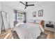 This bedroom features a standing mirror, light wood floors, large window and modern décor at 2202 E Lincoln Dr, Phoenix, AZ 85016