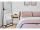 This bedroom has light wood floors, a standing mirror, large window and modern decor at 2202 E Lincoln Dr, Phoenix, AZ 85016