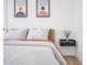 This bedroom features modern décor, light wood floors, a floating nightstand and comfortable bedding at 2202 E Lincoln Dr, Phoenix, AZ 85016