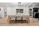 Elegant dining room with modern lighting, neutral tones, and view to the kitchen at 2202 E Lincoln Dr, Phoenix, AZ 85016