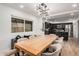 Spacious dining room with modern lighting, light wood table, and view to the kitchen at 2202 E Lincoln Dr, Phoenix, AZ 85016