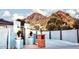 Desert home with concrete driveway, decorative wrought iron gate, and mountain views at 2202 E Lincoln Dr, Phoenix, AZ 85016