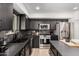 Modern kitchen with black cabinets, stainless steel appliances, and a functional layout at 2202 E Lincoln Dr, Phoenix, AZ 85016