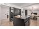 Stylish kitchen island featuring sleek black cabinets with seating at 2202 E Lincoln Dr, Phoenix, AZ 85016