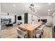 Open-concept living room featuring a dining area, modern lighting, and comfortable seating at 2202 E Lincoln Dr, Phoenix, AZ 85016