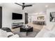 Open living room with light wood floors, modern furnishings and seamless flow to the dining area at 2202 E Lincoln Dr, Phoenix, AZ 85016