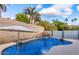 Inviting pool with a rock waterfall feature and lush landscaping creating a private oasis at 2202 E Lincoln Dr, Phoenix, AZ 85016