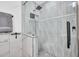 Luxurious shower with stylish tile, glass doors, and modern showerhead at 2202 E Lincoln Dr, Phoenix, AZ 85016